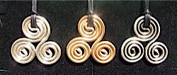 triskelion and triskele copper harmoniser pendants plated in silver, rose gold and ruthenium